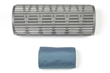 rolled up polyurethane mat and folded air mattress for camping and tourism isolated on white background