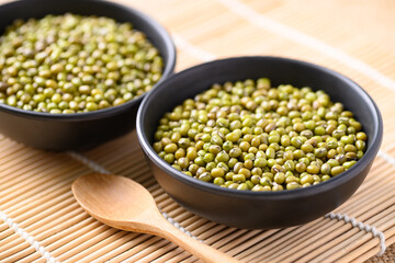 Mung bean seeds in a bowl with spoon, Food ingredients in Asian cuisine and produce mung bean sprout