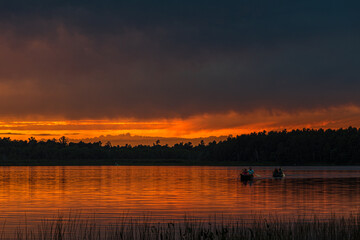 Naklejka premium Sunset above forest lake