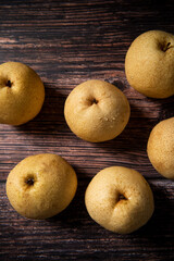 close-up of  fresh yellow pear on a wooden table