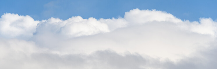 Blue sky with white clouds on a spring day as a nature background
