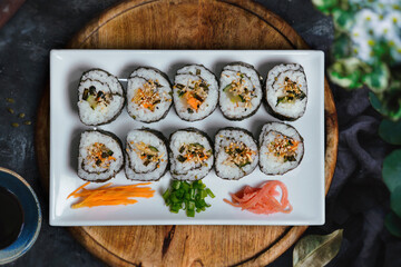 Top view of delicious maki sushi on a white plate © Rodolfo Lira/Wirestock