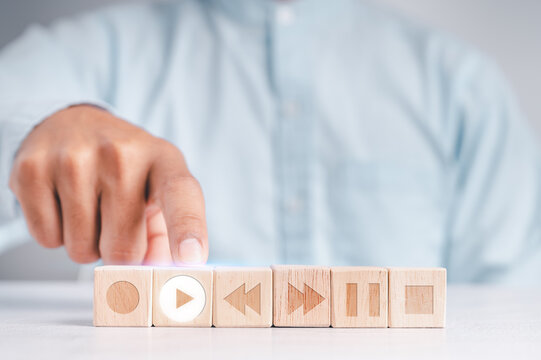People touch the wood blocks with their index fingers. With a music player button to select a play icon