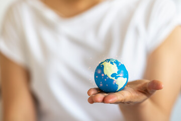 Closeup of mini world ball on woman hand.