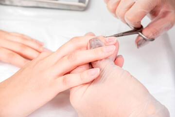 Obraz na płótnie Canvas Close-up of female hands during a manicure procedure in the salon.
