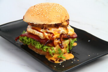 Freshly made giant hamburger sandwich with cheese and vegetables
