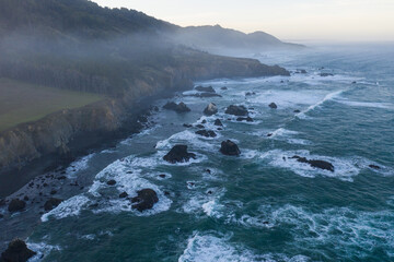 The Pacific Ocean meets the rugged, rocky shore of Northern California in Mendocino on a beautiful day. This region is known for its scenic mountains, forests, and coastline.