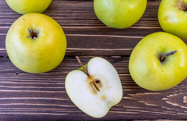 Green apples on wooden background