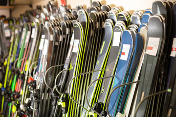 Large selection of skis for sale in the sports equipment store at mountain ski resort