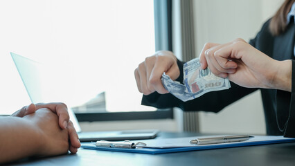 Government officials hand tear the dollar bill  refusing money to take the bribe money from...