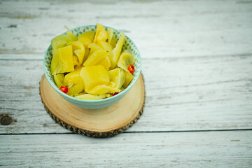 Cutting pickled lettuce with chilly in the bowl. Famous appetizer menu.