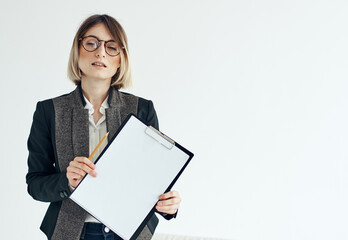 Business woman in a jacket manager model glasses and a white sheet of paper