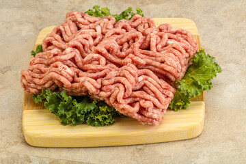 Raw pork minced meat over board