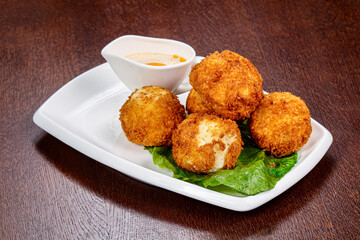 Fried cheese balls with sauce