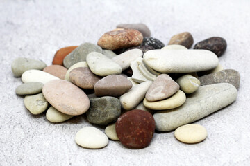 Fototapeta na wymiar Different sea stones on a gray background
