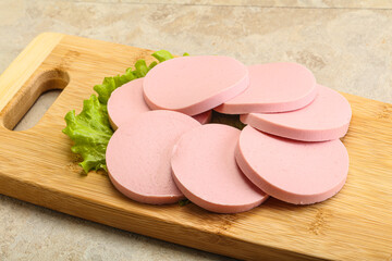 Sliced sausage snak over board