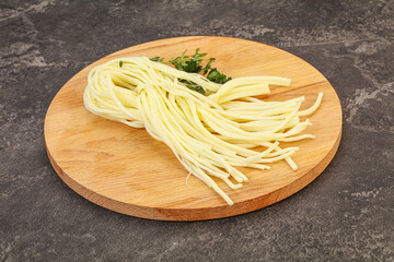 Chechil spaghetti cheese over board