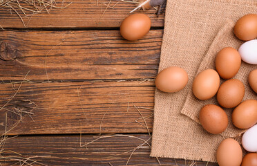 Fresh eggs on an old wooden table On an organic farm - top view.