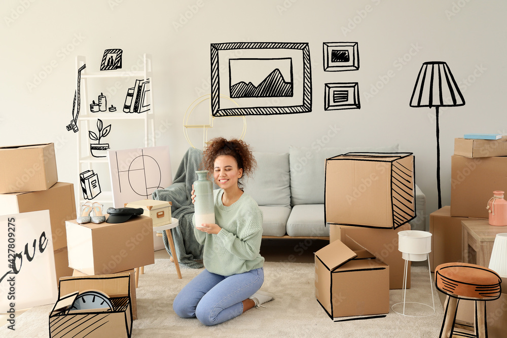 Wall mural Young woman with belongings in her new home on moving day