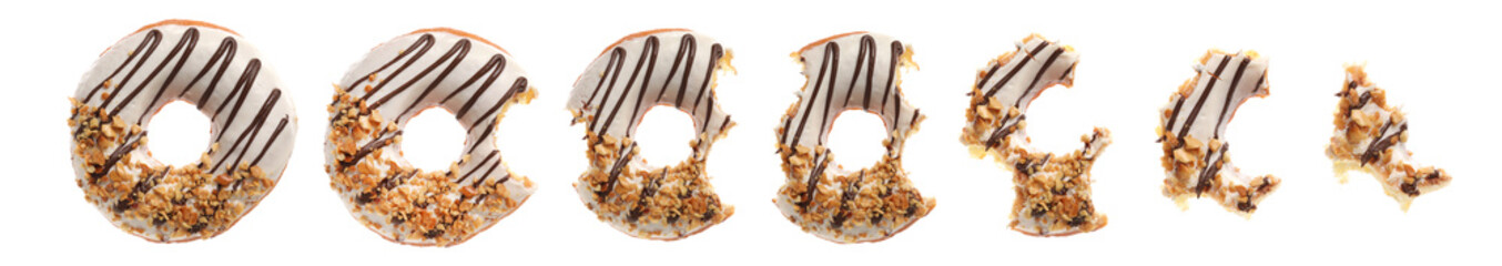 Process of eating tasty donut on white background