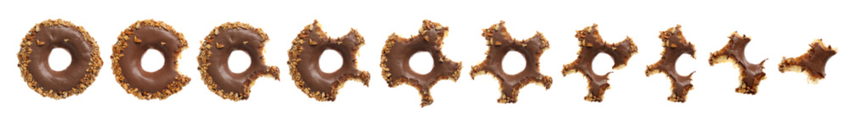 Process of eating tasty donut on white background