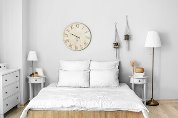 Interior of light modern bedroom with lamps