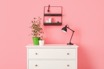 Modern chest of drawers near color wall in room