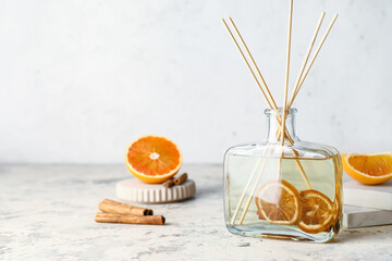 Citrus reed diffuser with cinnamon on table