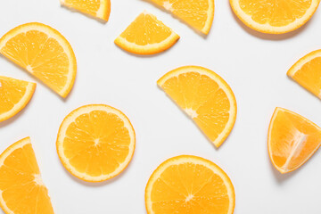 Fototapeta na wymiar Tasty orange pieces on white background