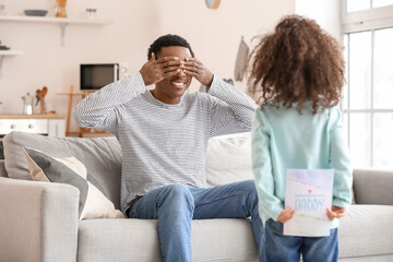 Cute African-American girl greeting her dad on Father's Day
