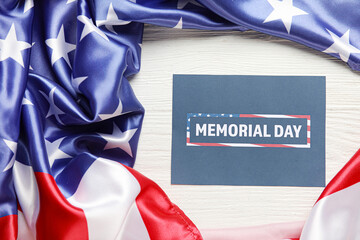 Fototapeta na wymiar Paper sheet with text MEMORIAL DAY and USA flag on white wooden background
