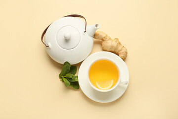 Teapot and cup of tea with ginger on color background