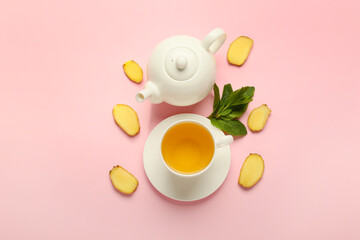 Teapot and cup of tea with ginger and mint on color background