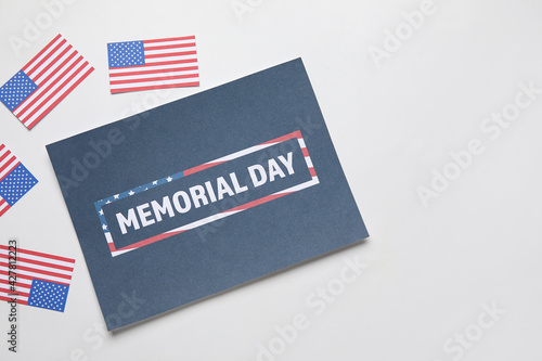 Greeting card for Memorial Day celebration with USA flags on white background