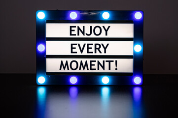 Lightbox with blue lights with words - Enjoy every moment!