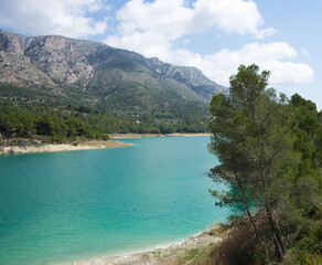 An idyllic lake between mountains.Guadalest reservoir in Alicante, Spain.