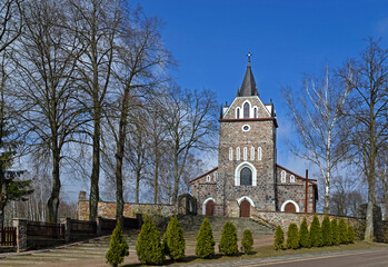 Fototapeta na wymiar consecrated in 1926, the neo-Gothic Catholic church of Our Lady of Czestochowa and Saint Kazimierz in the village of Majewo Koscielne in Podlasie, Poland. General view of the temple