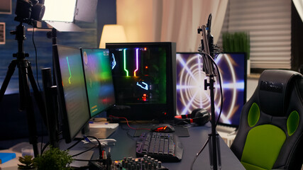 Slide view of streaming home studio equipped with professional equipment during esport competition. Gamer playing space shooter video games late at night