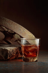 Glass of whiskey on a rusty background.