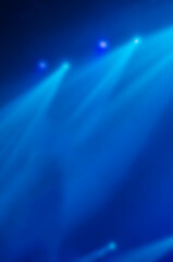 Defocused composition with blue stage light on concerton stage.