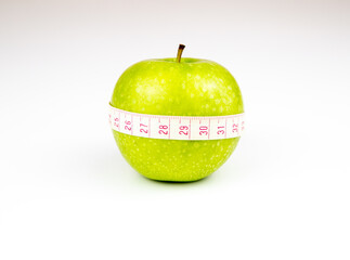 Green apple with measuring tape