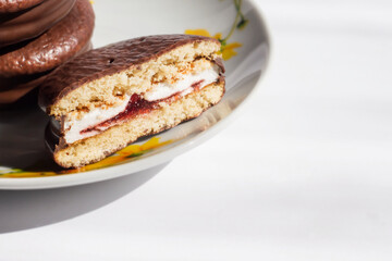 Chocolate chip cookies cut in half with jam. Dessert, cake.