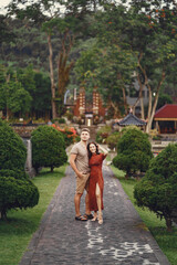 Fototapeta na wymiar Couple standing on a temple background
