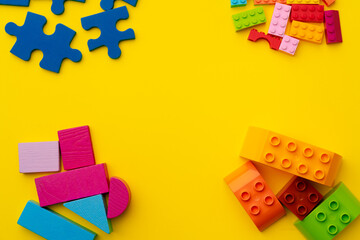 Obraz premium Toy kid's constructor on yellow background top view