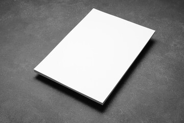Blank sheet of paper on dark background
