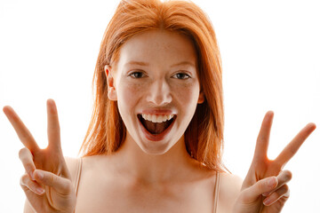 Portrait of a happy young redhead woman with healthy freckled skin
