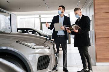 Salesman and customer in a car dealership