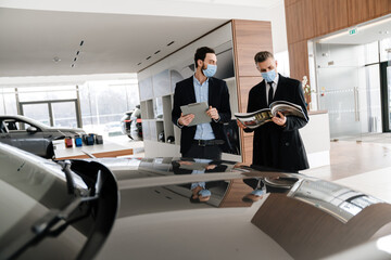 Salesman and customer in a car dealership