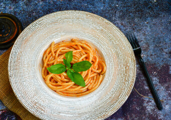 Spaghetti  bolognese .Italian home made meal Fresh  bucatini pasta with tomato sauce, basil, herbs ,parmesan cheese ,fresh cherry tomatoes and parsley on wooden background. Kitchen Poster 