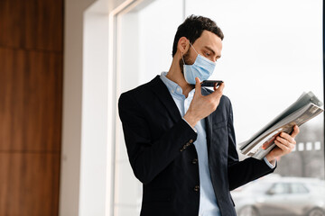 Man in face mask talking with the client on mobile phone